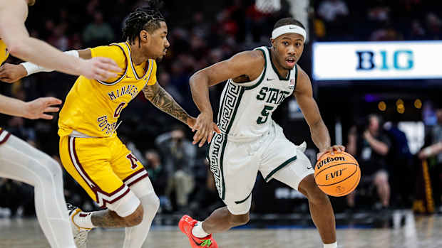 Michigan State guard Tre Holloman (5) dribbles against Minnesota guard Elijah Hawkins (0) during the second half of Second Round of Big Ten tournament at Target Center in Minneapolis, Minn. on Thursday, March 14, 2024.